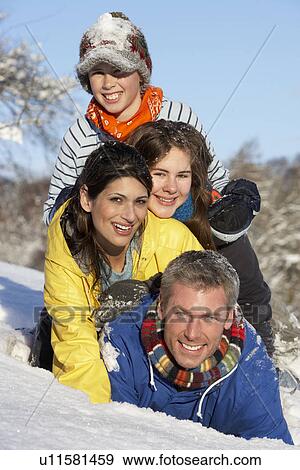 Young Family Having Fun In Snowy Landscape View Large Photo Image Stock Photo - Young Family Having Fun In Snowy Landscape. Fotosearch