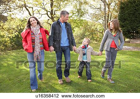 Young Family Outdoors Walking Through Park View Large Photo Image Stock Image - Young Family Outdoors Walking Through Park. Fotosearch