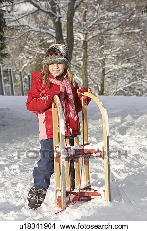 Young Girl Holding Sledge In Snowy Landscape View Large Photo Image Picture - Young Girl Holding Sledge In Snowy Landscape. Fotosearch