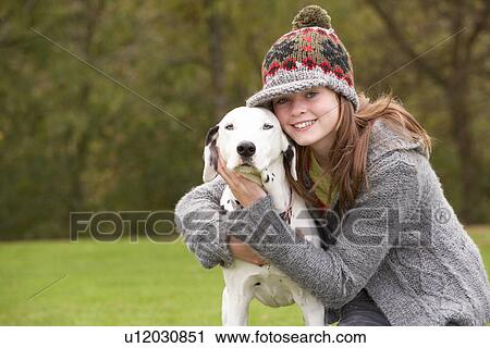 Stock Image - Young Girl Talking Dog For Walk. Fotosearch