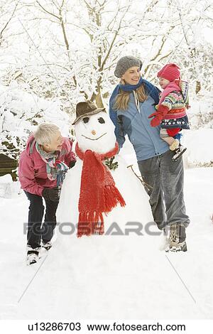Young Girl With Grandmother And Mother Building Snowman In Garden View Large Photo Image Stock Image - Young Girl With Grandmother And Mother Building Snowman In Garden. Fotosearch