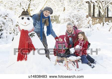 Young Girl With Grandmother And Mother Building Snowman In Garden View Large Photo Image Stock Image - Young Girl With Grandmother And Mother Building Snowman In Garden. Fotosearch