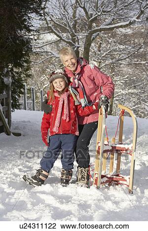 Young Girl With Grandmother Holding Sledge In Snowy Landscape View Large Photo Image Stock Image - Young Girl With Grandmother Holding Sledge In Snowy Landscape. Fotosearch