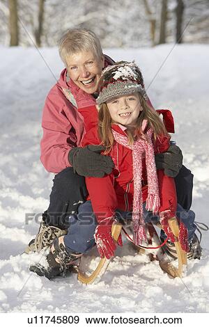 Young Girl With Grandmother Riding On Sledge In Snowy Landscape View Large Photo Image Stock Photo - Young Girl With Grandmother Riding On Sledge In Snowy Landscape. Fotosearch