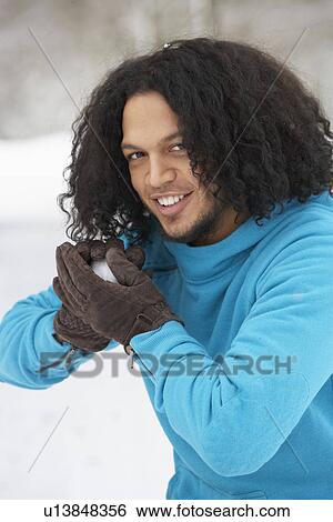 Stock Photograph - Young Man About To Throw Snowball. Fotosearch