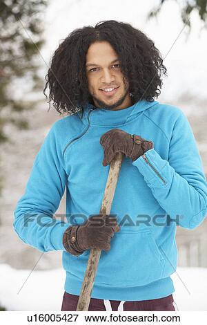 Stock Photo - Young Man Clearing Snow From Drive. Fotosearch
