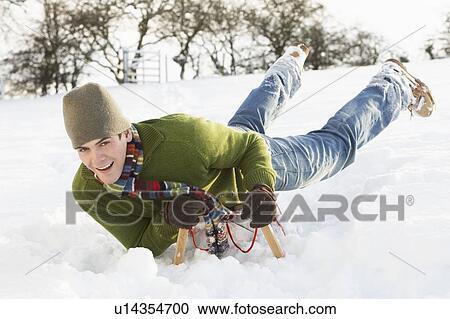 Young Man Riding On Sledge In Snowy Landscape View Large Photo Image Stock Image - Young Man Riding On Sledge In Snowy Landscape. Fotosearch