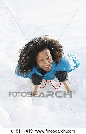 Young Man Riding On Sledge In Snowy Landscape View Large Photo Image Stock Photo - Young Man Riding On Sledge In Snowy Landscape. Fotosearch