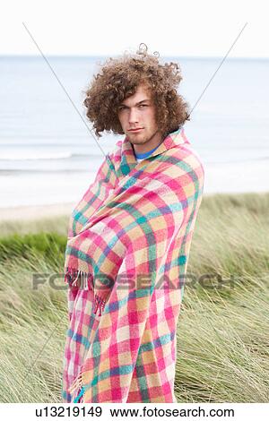 Young Man Standing In Sand Dunes Wrapped In Blanket View Large Photo Image Stock Photo - Young Man Standing In Sand Dunes Wrapped In Blanket. Fotosearch