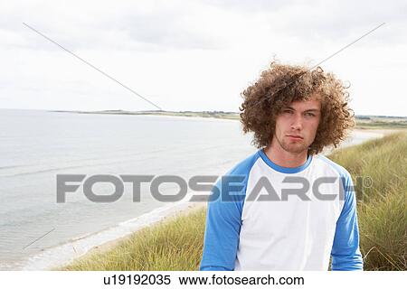 Young Man Standing In Sand Dunes View Large Photo Image Stock Photography - Young Man Standing In Sand Dunes. Fotosearch
