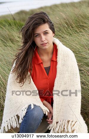 Young Woman Standing In Sand Dunes Wrapped In Blanket View Large Photo Image Stock Photo - Young Woman Standing In Sand Dunes Wrapped In Blanket. Fotosearch