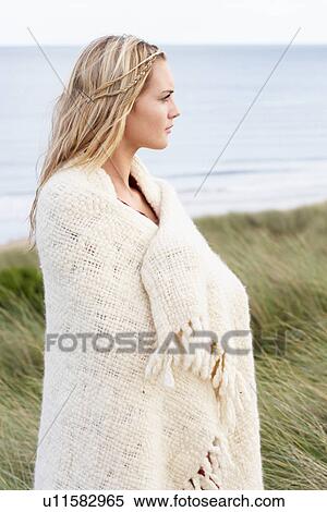 Young Woman Standing In Sand Dunes Wrapped In Blanket View Large Photo Image Stock Photography - Young Woman Standing In Sand Dunes Wrapped In Blanket. Fotosearch