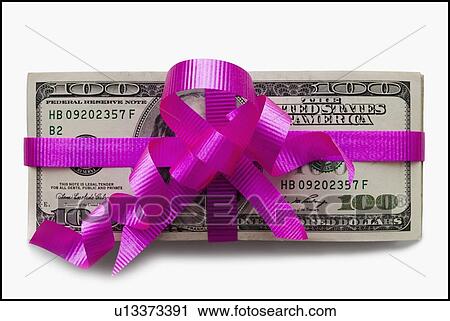 Stock Image - American currency tied with a pink bow. Fotosearch