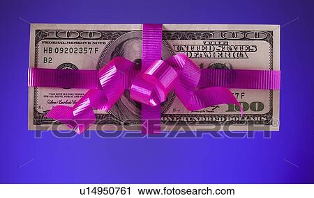Stock Image - American currency tied with a pink bow. Fotosearch