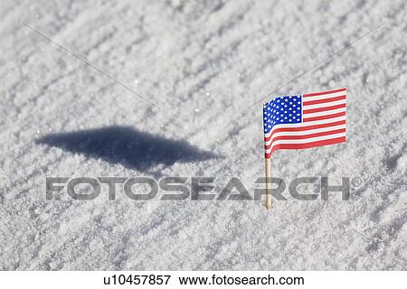 Stock Photo - American flag in the snow. Fotosearch
