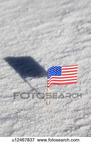 Stock Photo - American flag in the snow. Fotosearch