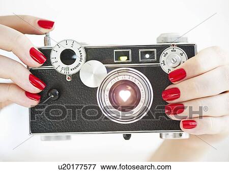 Antique camera being held by woman wearing red nail polish View Large Photo Image Stock Photo - Antique camera being held by woman wearing red nail polish. Fotosearch
