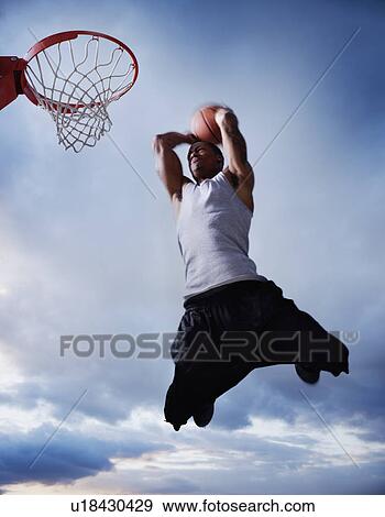 Stock Photo - Basketball player jumping. Fotosearch
