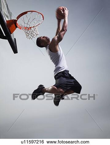 Basketball player jumping View Large Photo Image Stock Photograph - Basketball player jumping. Fotosearch