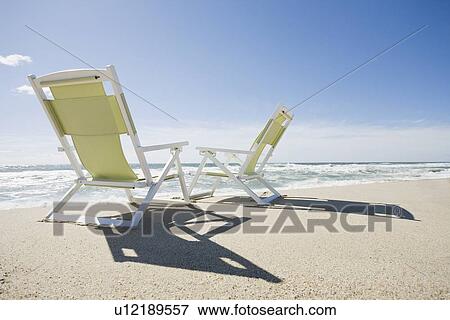 Stock Photo - Beach chairs by the ocean. Fotosearch