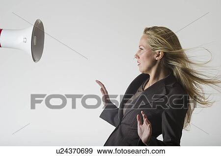 Bullhorn beside businesswoman View Large Photo Image Stock Photo - Bullhorn beside businesswoman. Fotosearch