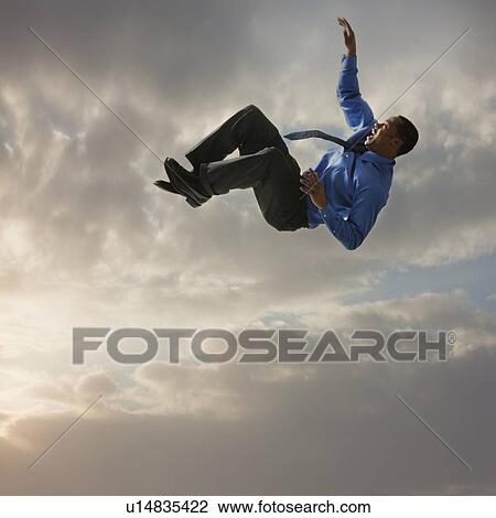 Businessman falling from the sky View Large Photo Image Stock Image - Businessman falling from the sky. Fotosearch