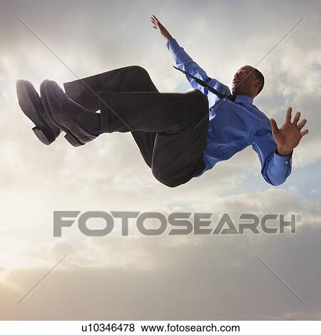 Businessman falling from the sky View Large Photo Image Stock Photo - Businessman falling from the sky. Fotosearch