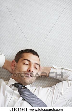 Stock Image - Businessman having a nap. Fotosearch