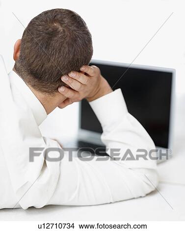 Picture - Businessman looking at computer. Fotosearch