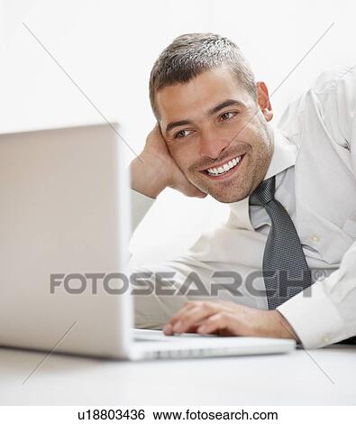 Businessman looking at computer View Large Photo Image Stock Photograph - Businessman looking at computer. Fotosearch