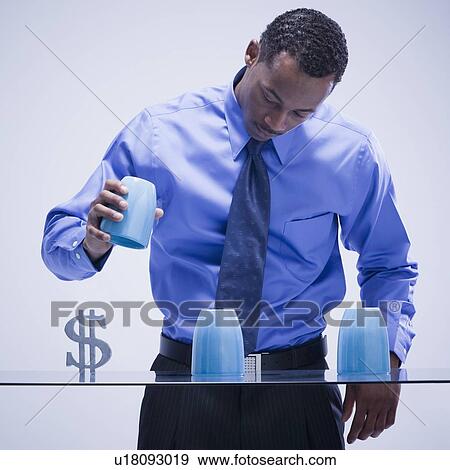 Stock Photo - Businessman playing game of chance. Fotosearch