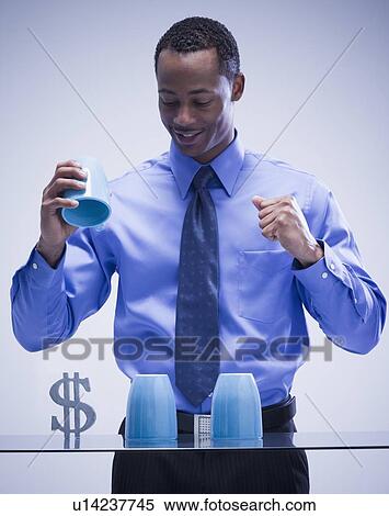 Stock Photography - Businessman playing game of chance. Fotosearch