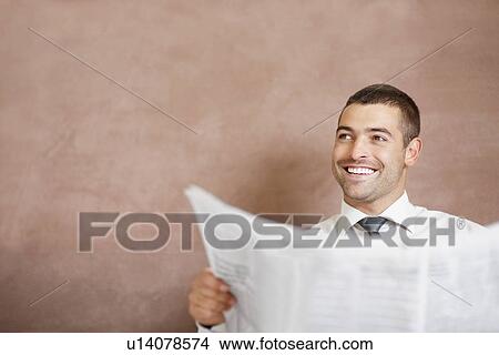 Picture - Businessman reading newspaper. Fotosearch
