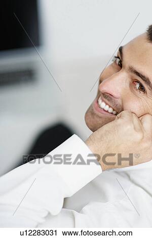 Stock Image - Businessman talking on phone. Fotosearch