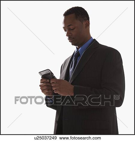 Businessman texting View Large Photo Image Stock Photo - Businessman texting. Fotosearch