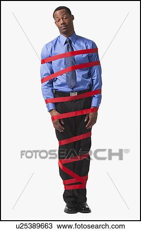 Stock Image - Businessman wrapped in red tape. Fotosearch
