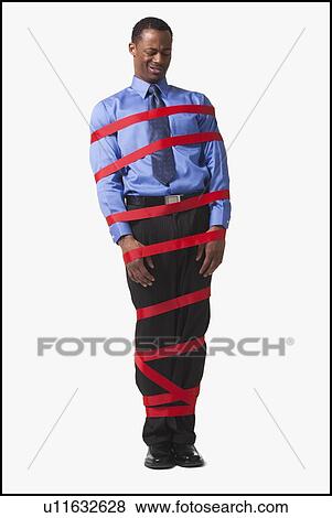 Stock Photo - Businessman wrapped in red tape. Fotosearch