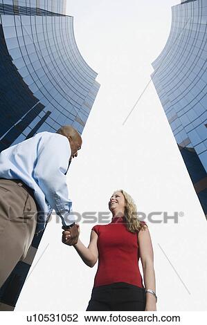 Co-workers shaking hands View Large Photo Image Stock Image - Co-workers shaking hands. Fotosearch