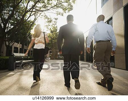 Stock Photo - Co-workers walking outside. Fotosearch