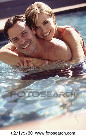 Couple embracing in pool View Large Photo Image Stock Image - Couple embracing in pool. Fotosearch
