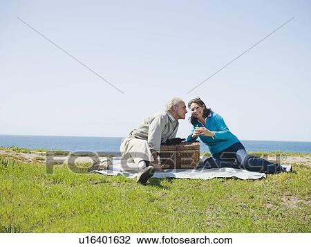 Stock Image - Couple having picnic. Fotosearch