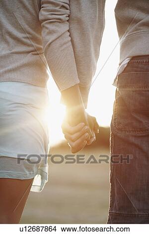 Couple holding hands View Large Photo Image Picture - Couple holding hands. Fotosearch