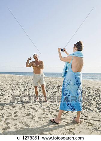 Stock Image - Couple on beach. Fotosearch