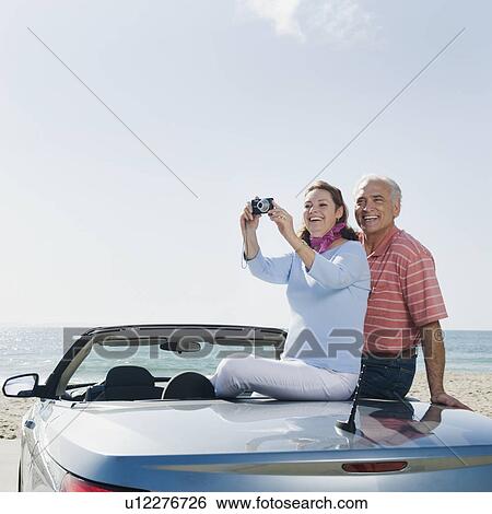 Couple on road trip View Large Photo Image Stock Photograph - Couple on road trip. Fotosearch
