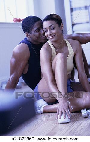 Stock Image - Couple relaxing after exercising. Fotosearch