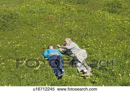 Couple relaxing in meadow View Large Photo Image Stock Photography - Couple relaxing in meadow. Fotosearch