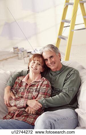 Stock Image - Couple relaxing on couch. Fotosearch