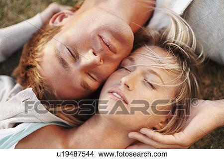 Couple relaxing on the grass View Large Photo Image Picture - Couple relaxing on the grass. Fotosearch