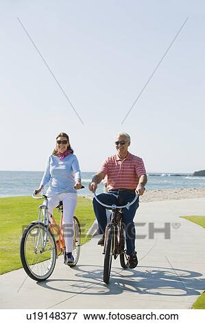 Stock Photo - Couple riding bicycles. Fotosearch