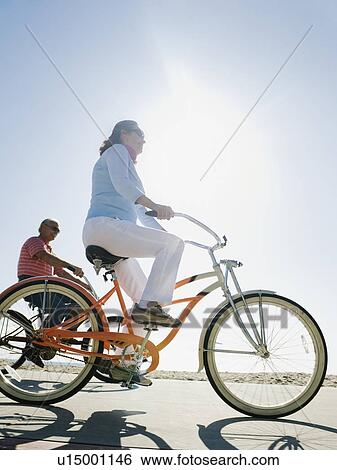 Stock Photograph - Couple riding bicycles. Fotosearch